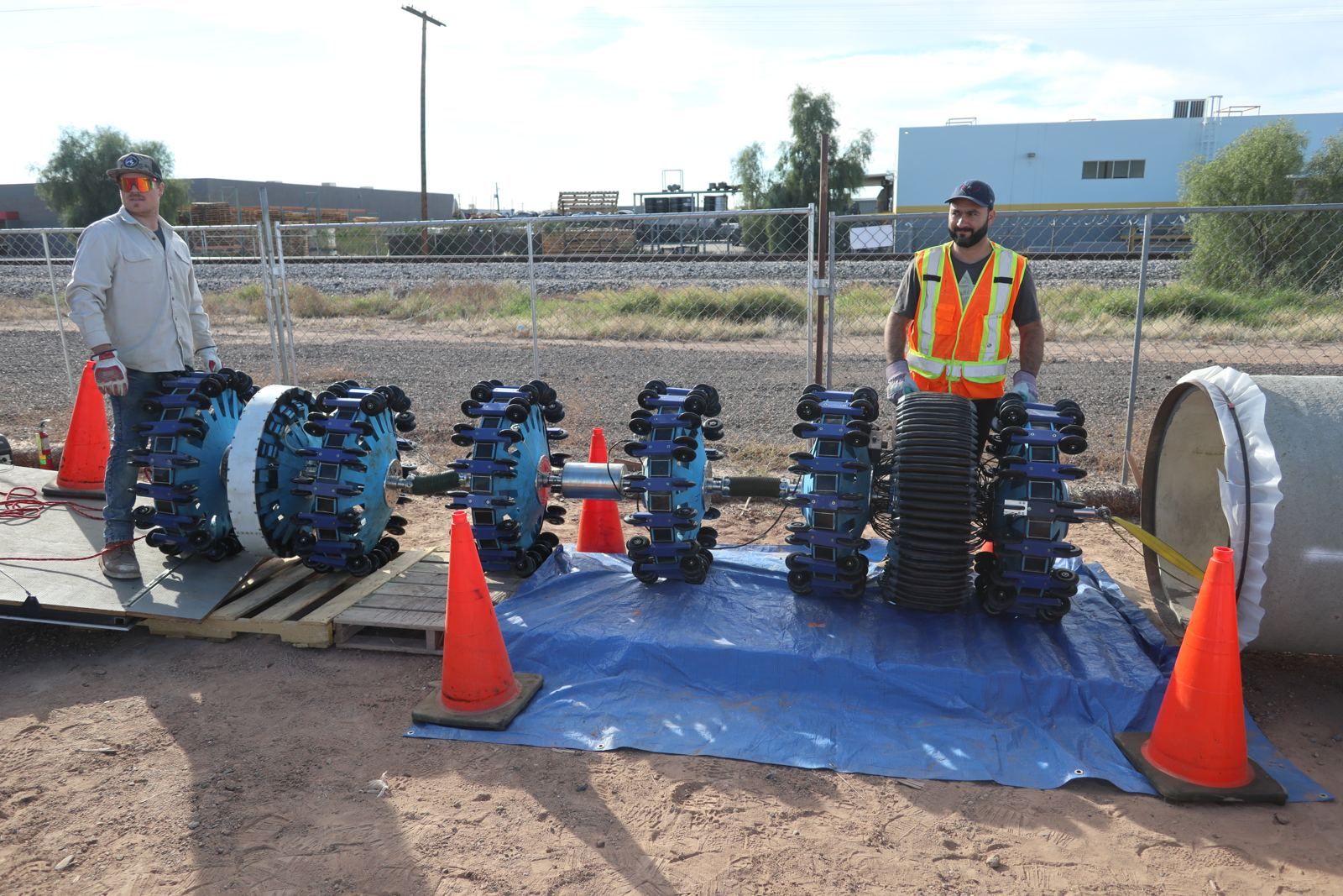 PICA remote field testing tool strings laid out beside concrete pressure pipe before an inspection run