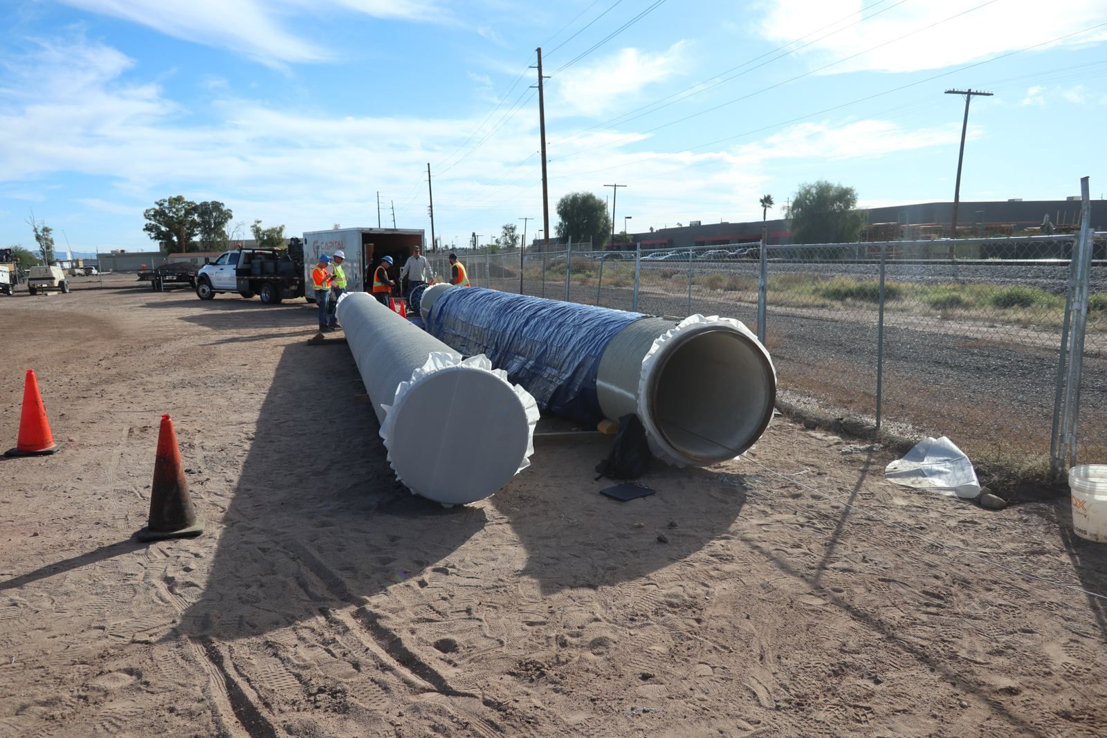 Sections of concrete pressure pipe staged above ground