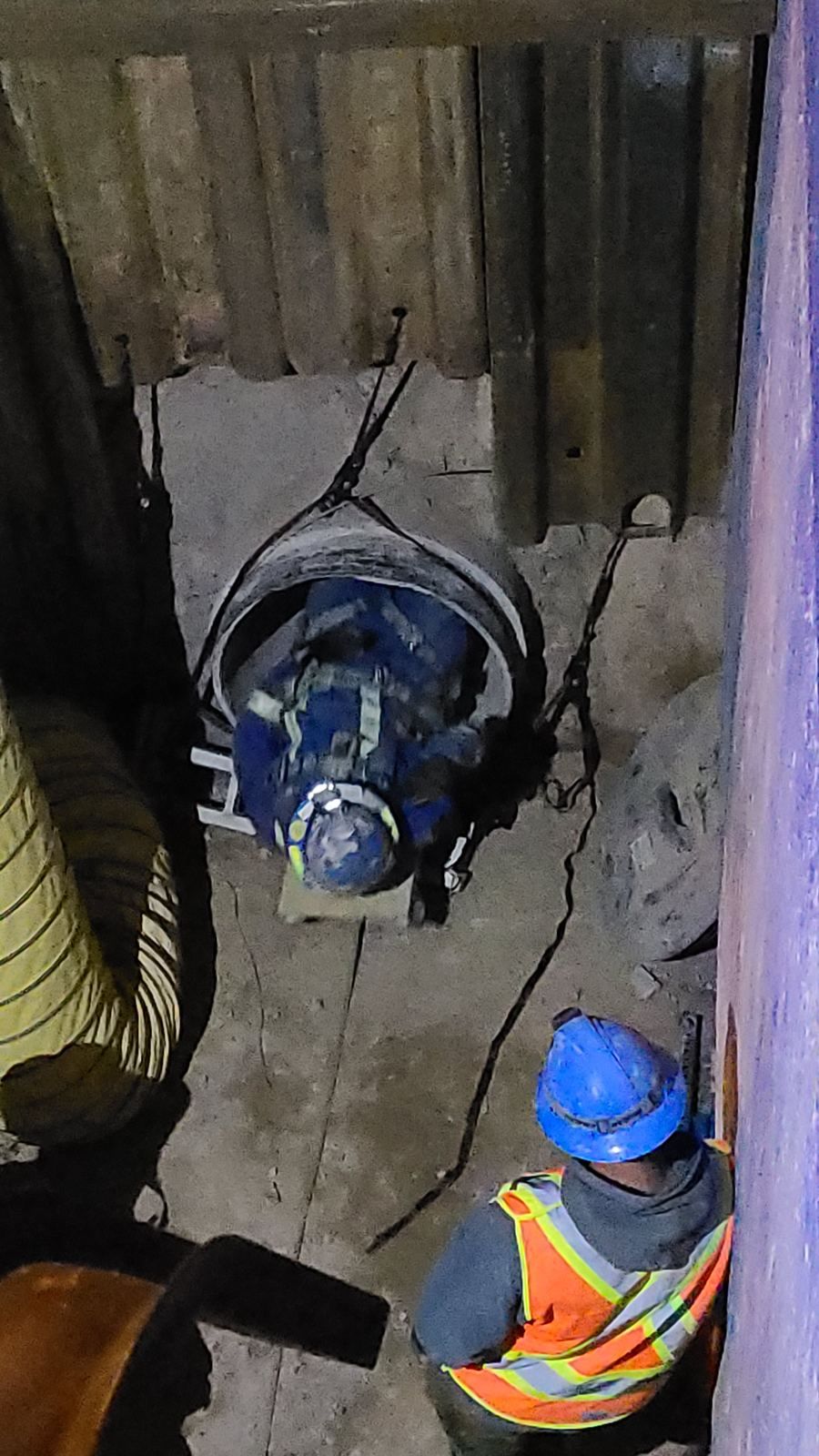 Crew guiding an inspection tool into an open pipe end at the launch point