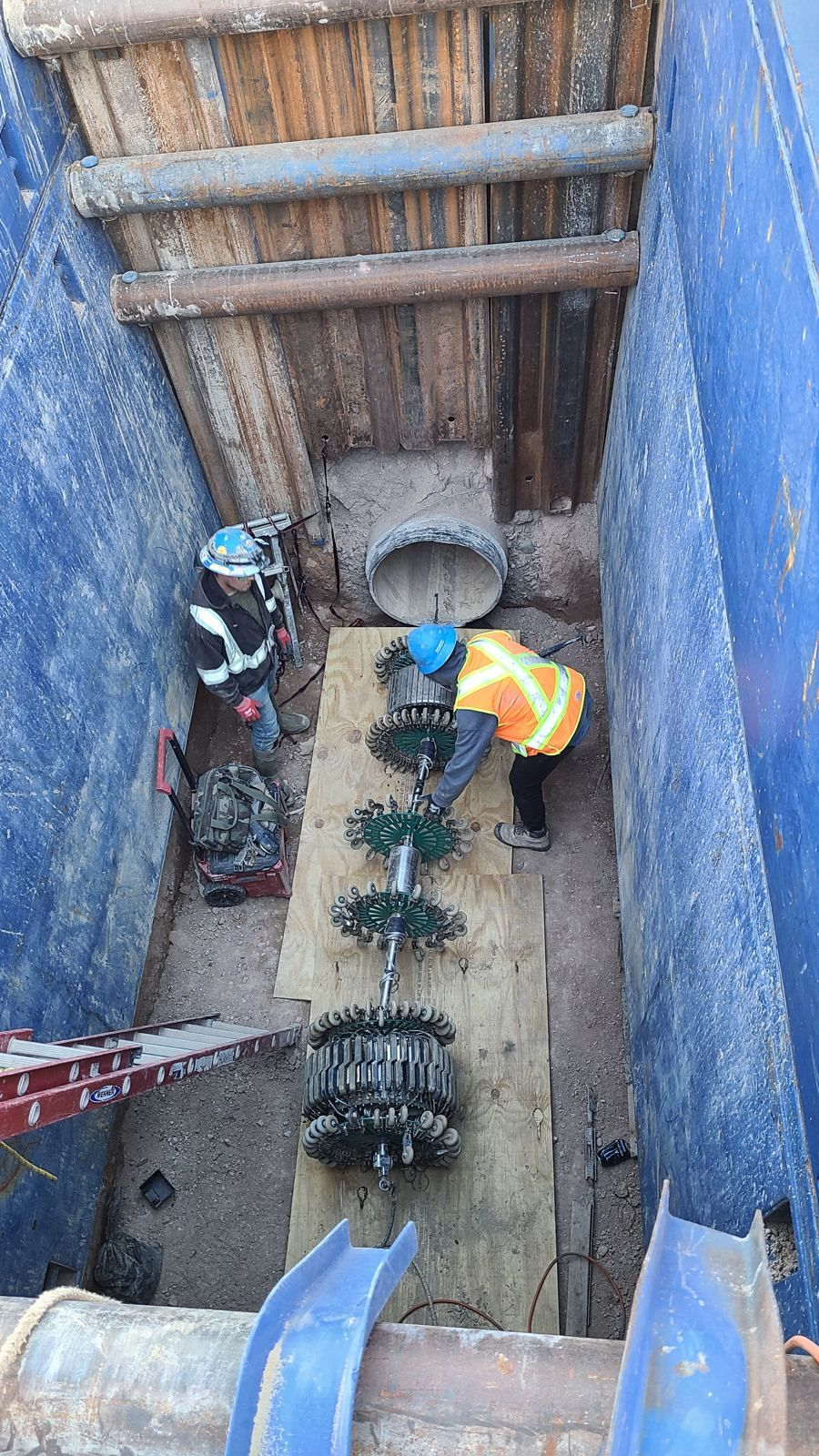 Inspection tool string laid out in a shored excavation ready for launch